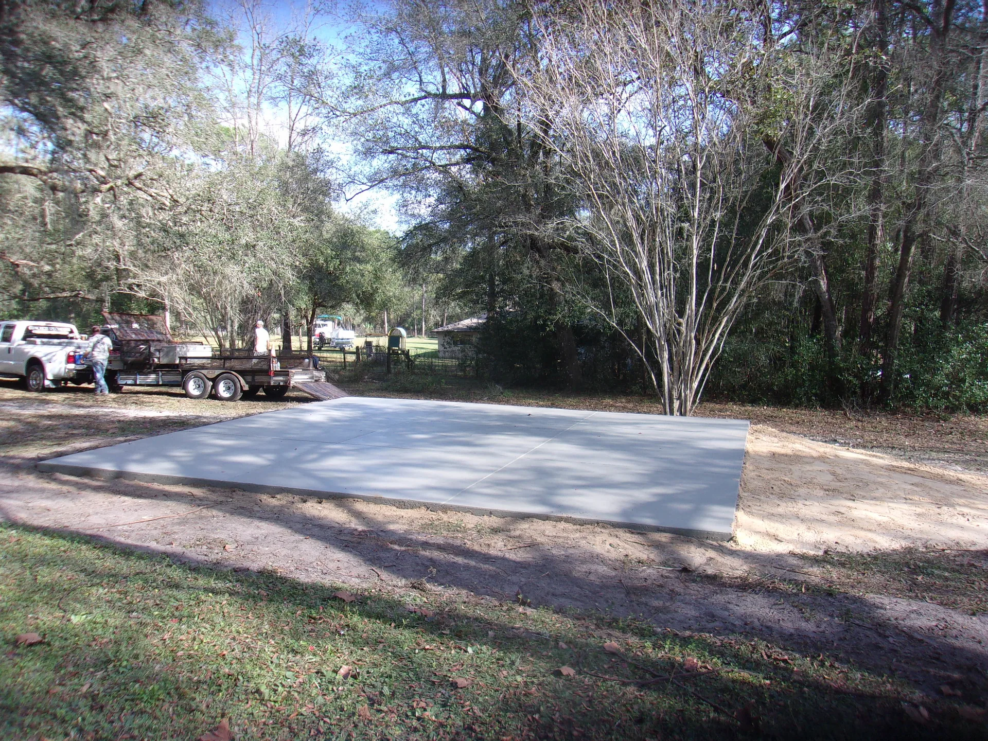 Granular base being compacted for a pole barn pad on a Ramara Township farm property.