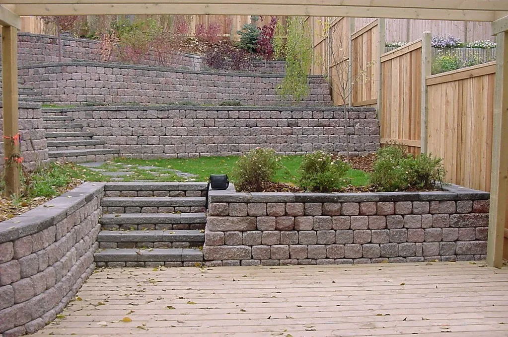Aging timber retaining wall showing outward lean on an Orillia subdivision property.